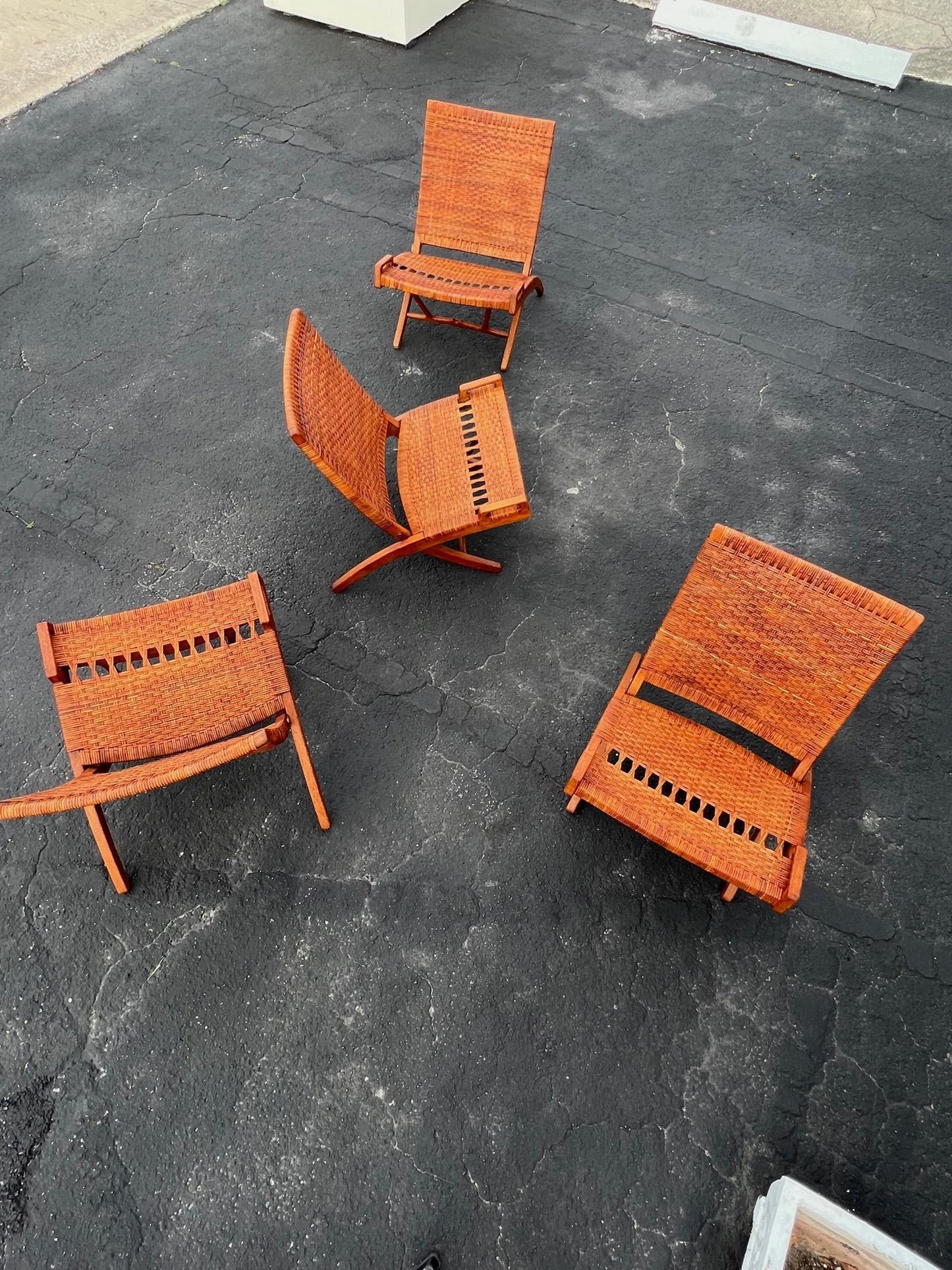 A Set Of Four Hans Wegner Folding Chairs